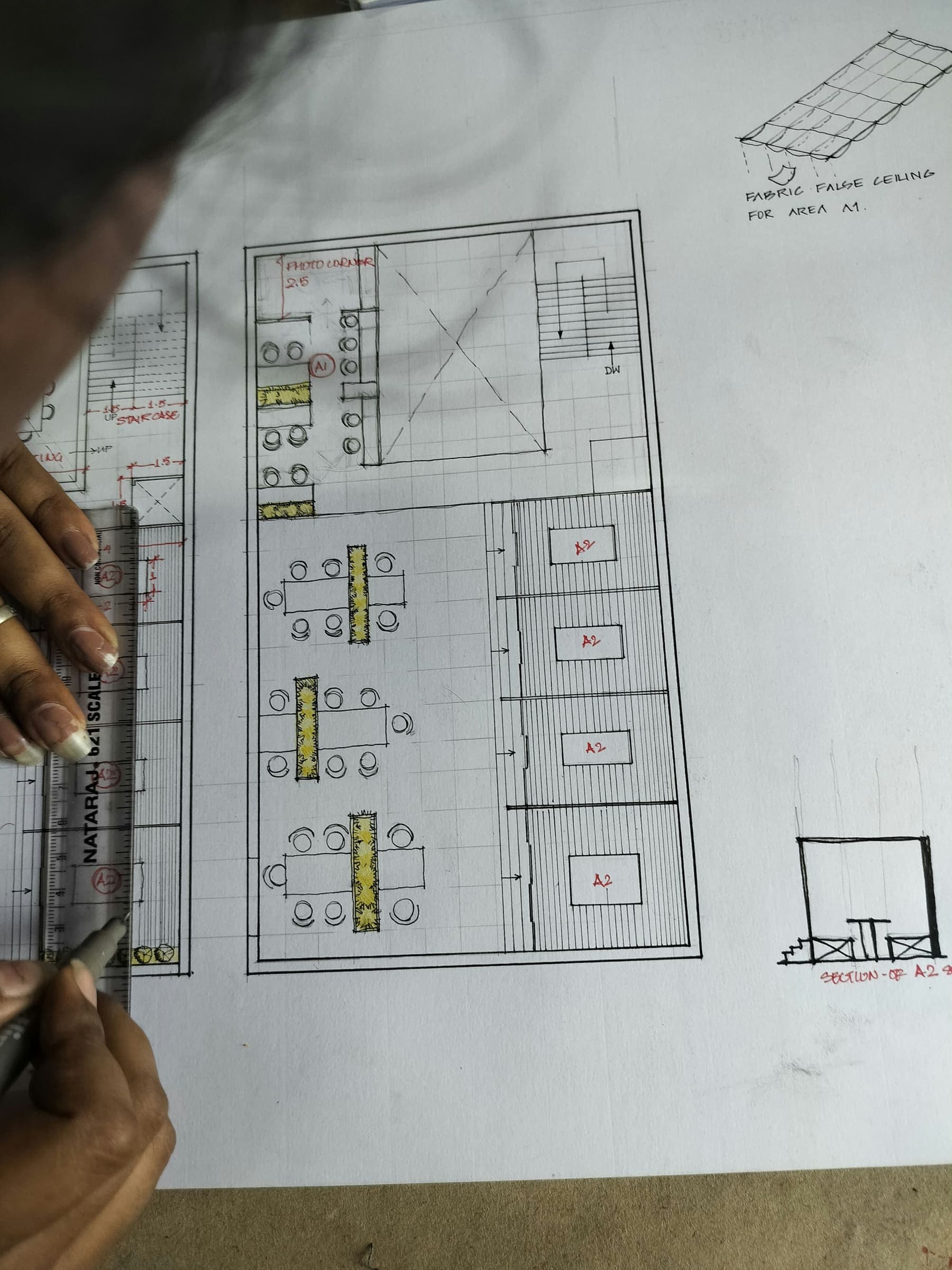 Marking up a floor plan by hand at the drawing board