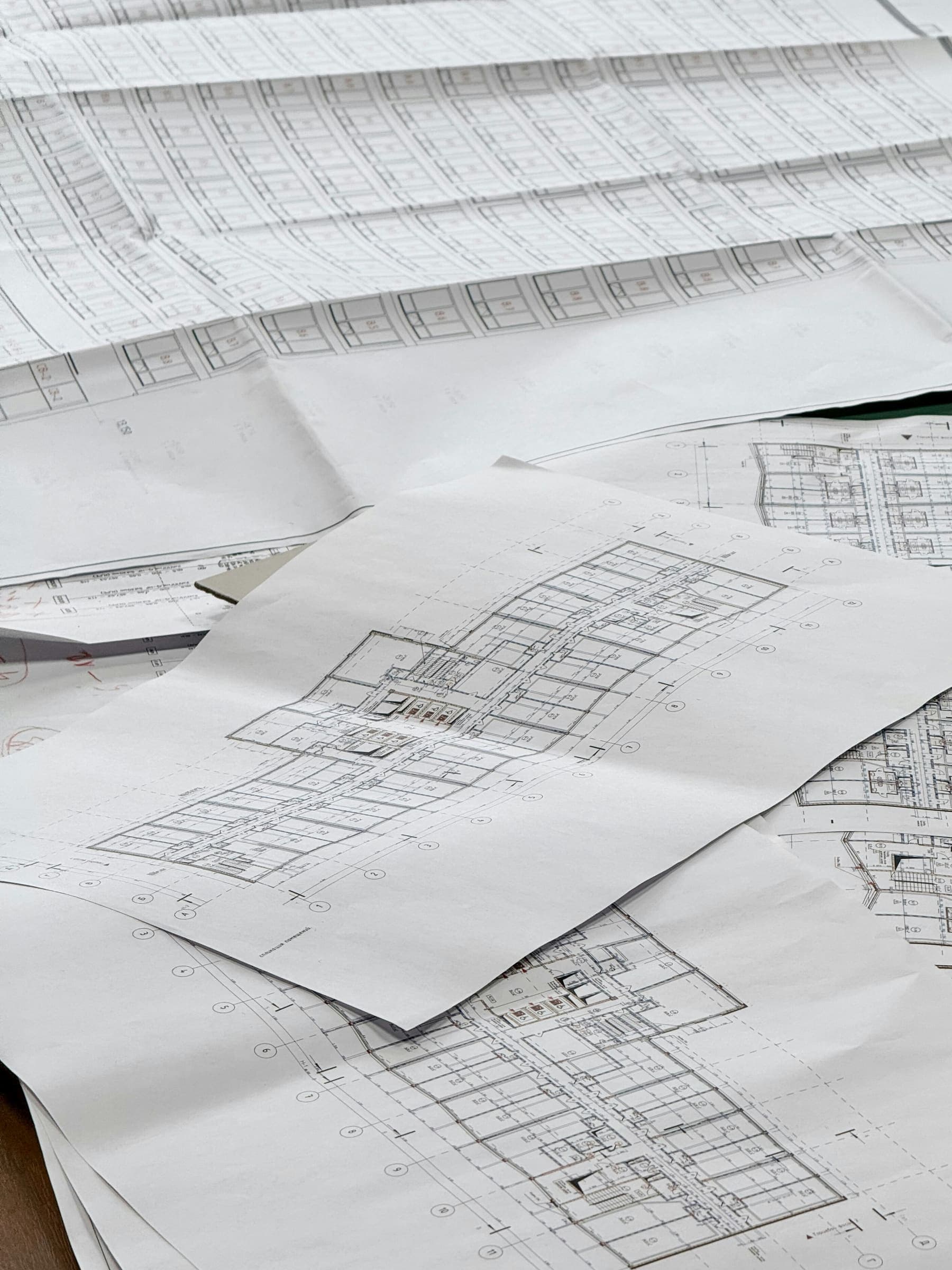 A stack of marked-up floor plans